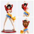 Figurine of a character in a red shirt, blue shorts, and yellow scarf with a straw hat on a white background.