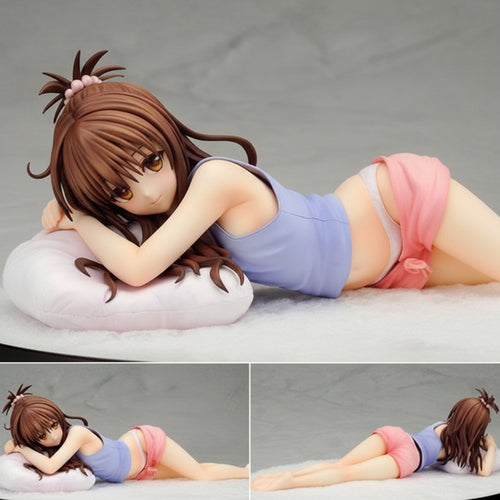 Anime character figurine lying on a pillow with close-up details