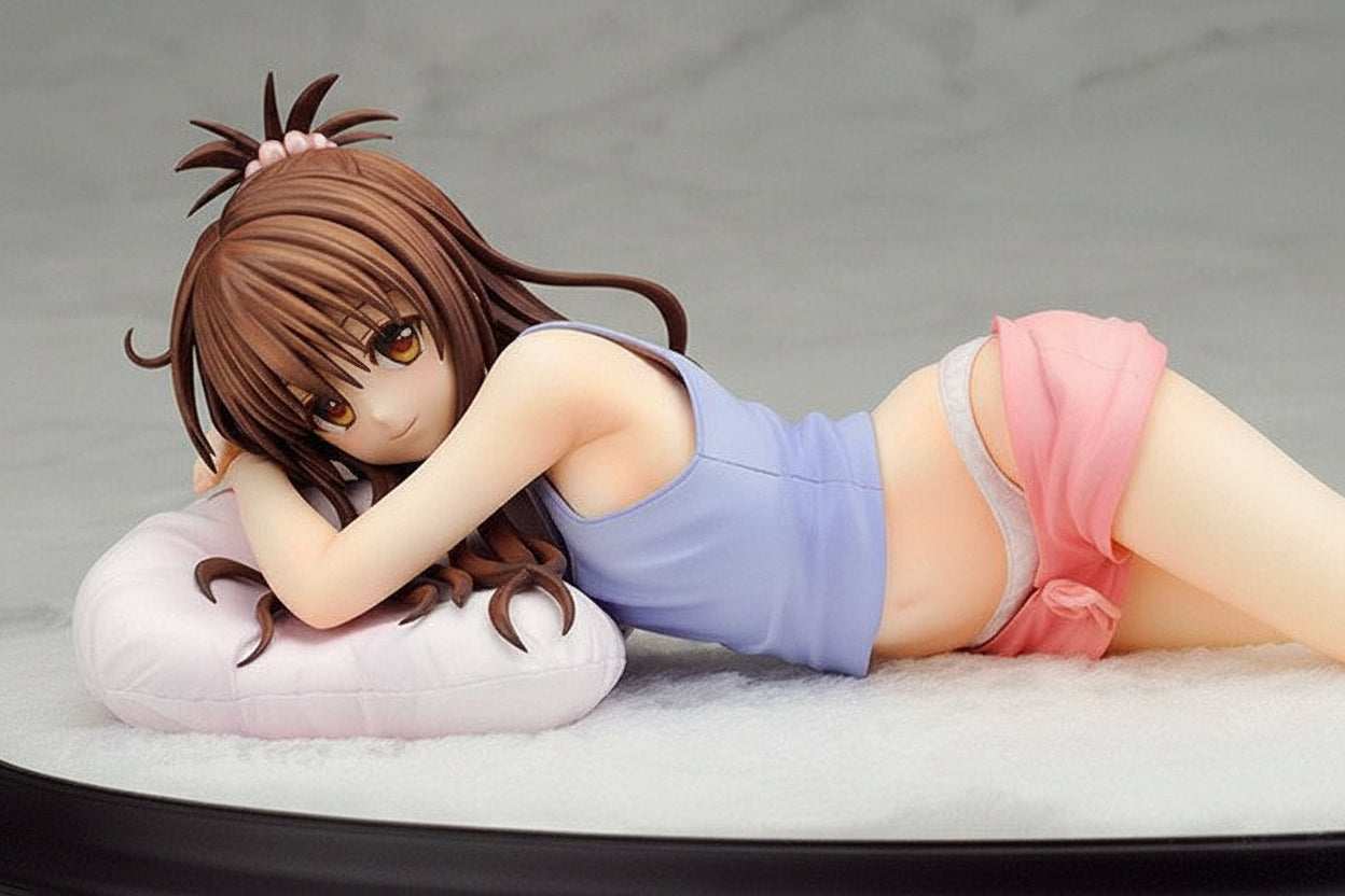 Figurine of a character lying on a bed with a gray background
