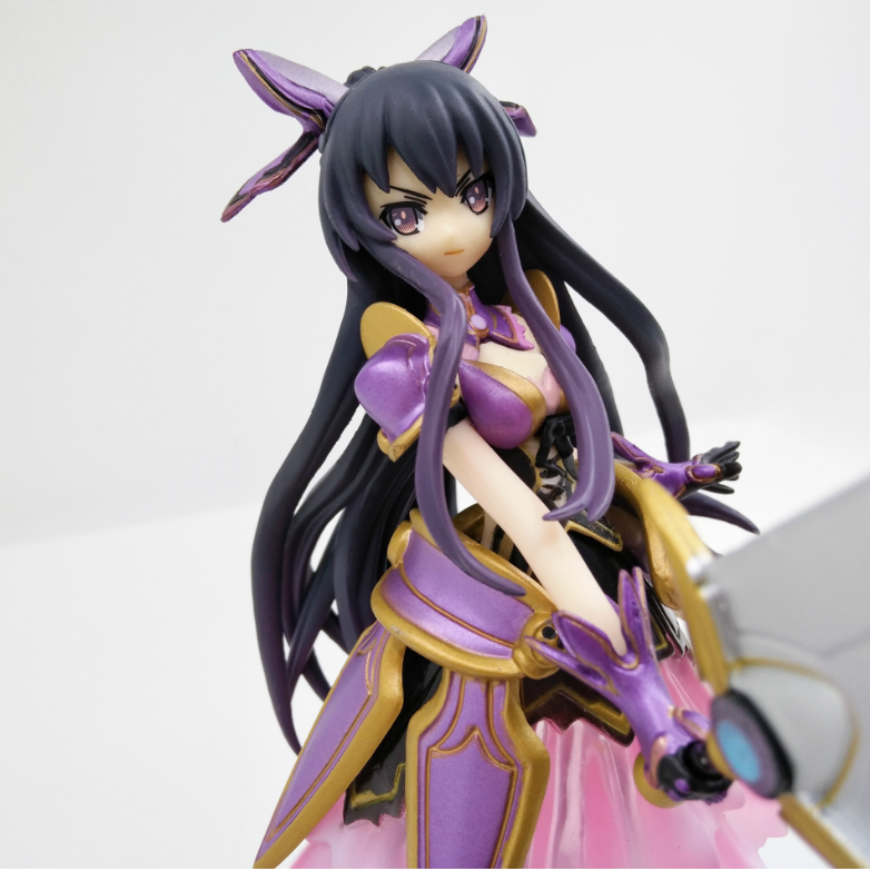 Anime character figurine with long black hair and purple accents on a white background
