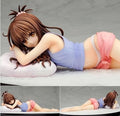 Anime character figurine lying on a pillow with close-up details