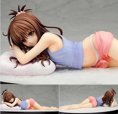 Anime character figurine lying on a pillow with close-up details