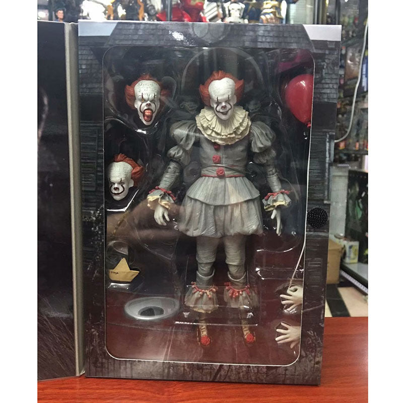 Action figure of a clown in packaging on a wooden surface
