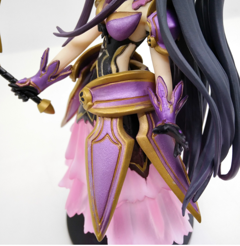 Figurine with purple and gold armor on a white background