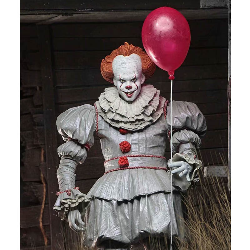 Clown with red balloon in front of wooden wall