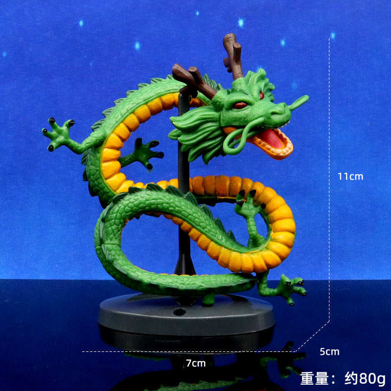 Green and orange dragon figurine on a blue background with measurements indicated.